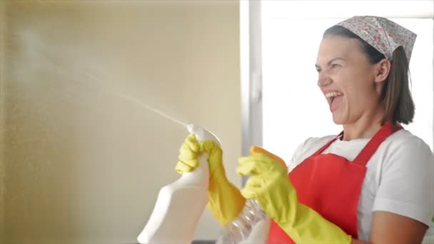 Tired of boring work, the housewife started a fun game with the Hand Sprayers. — Stock Video