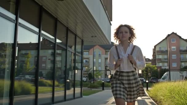 Estudante adolescente bonito vai para a escola depois de férias de verão. A rapariga sorri. De volta à escola. — Vídeo de Stock