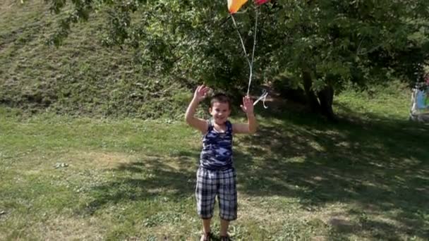 Молодий хлопчик і повітряні кулі, повільний рух — стокове відео