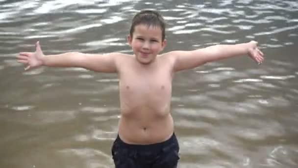 Happy boy on background of the river — Stock Video