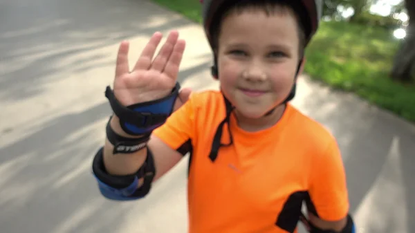 Happy boy riding in the Park on rollers — Stock Photo, Image