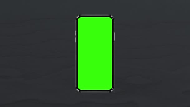 智能手机与一个空的绿色屏幕，前视图，背对着桌子顶部由黑色木材制成。4K动画跟踪运动，以便在布局屏幕上演示。3D渲染 — 图库视频影像