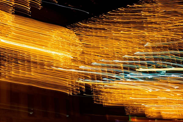 Speed of digital lights in motion. Bright orange neon glowing fast moving streams of light, along a trajectory. Fast energy flying wave line with flash lights. Swirl trace path on black background.