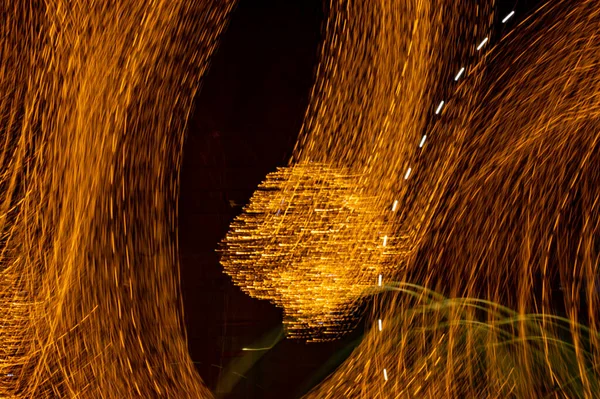 Speed of digital lights in motion. Bright orange neon glowing fast moving streams of light, along a trajectory. Fast energy flying wave line with flash lights. Swirl trace path on black background.