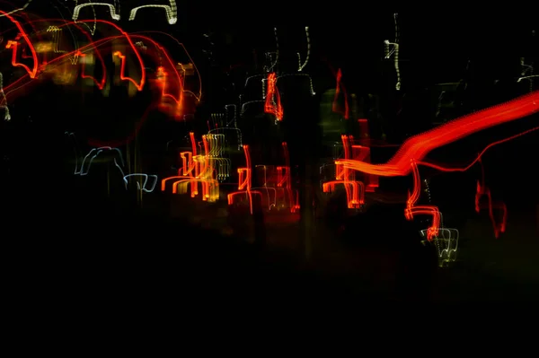 Speed of digital lights in motion. Bright red and white neon glowing fast moving streams of light, along a trajectory. Fast energy flying wave line with flash lights. Swirl trace path on black background.