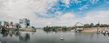 GERÇEK, DUESSELDORF - 14 AĞUSTOS 2020: Medienhafen 'de tekne. Medya limanında manzaralı Düsseldorf şehir manzarası