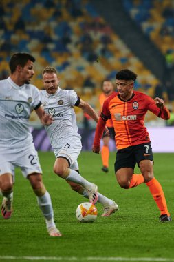 KYIV, UKRAINE - FEBRUARY 25, 2021: Dan Glaser vs Taison. NSC Olympic. The football match of UEFA Europa League FC Shakhtar - Maccabi Tel Aviv FC