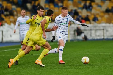KYIV, UKRAINE - MARCH 11, 2021:15 midfielder Viktor Tsygankov vs 24 midfielder Alfonso Pedraza and 14 midfielder Manu Trigueros during the match of UEFA Europa League Dynamo Kyiv vs Villarreal at NSC Olympic in Kyiv