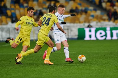 KYIV, UKRAINE - MARCH 11, 2021:15 midfielder Viktor Tsygankov vs 24 midfielder Alfonso Pedraza and 14 midfielder Manu Trigueros during the match of UEFA Europa League Dynamo Kyiv vs Villarreal at NSC Olympic in Kyiv
