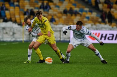 KYIV, UKRAINE - MARCH 11, 2021:4 defender Pau Torres vs 41 forward Artem Besedin and 94 defender Tomasz Kedziora during the match of UEFA Europa League Dynamo Kyiv vs Villarreal at NSC Olympic in Kyiv