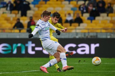 KYIV, UKRAINE - MARCH 11, 2021:14 midfielder Manu Trigueros vs 25 defender Illia Zabarnyi during the match of UEFA Europa League Dynamo Kyiv vs Villarreal at NSC Olympic in Kyiv