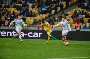 KYIV, UKRAINE - MARCH 11, 2021: 9 forward Carlos Bacca vs 25 defender Illia Zabarnyi, 94 defender Tomasz Kedziora during the match of UEFA Europa League Dynamo Kyiv vs Villarreal at NSC Olympic in Kyiv