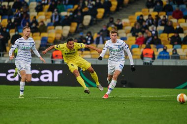 KYIV, UKRAINE - MARCH 11, 2021: 9 forward Carlos Bacca vs 25 defender Illia Zabarnyi, 94 defender Tomasz Kedziora during the match of UEFA Europa League Dynamo Kyiv vs Villarreal at NSC Olympic in Kyiv