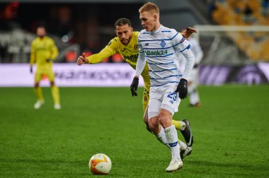 KYIV, UKRAINE - MARCH 11, 2021:25 midfielder Etienne Capoue vs 29 midfielder Vitaliy Buyalskiy during the match of UEFA Europa League Dynamo Kyiv vs Villarreal at NSC Olympic in Kyiv