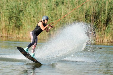 KHARKIV, UKRAINE - 31 Temmuz 2021: Ukrayna Şampiyonası. Wakeboardcu Kharkiv 'deki wakeboard etkinliğinde numaralar ve beceriler gösteriyor.