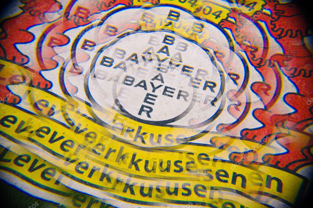 LEVERKUSEN, GERMANY - 17 DECEMBER, 2023: Creative multi-exposure of the Bayer 04 Leverkusen crest on pitch, with colorful chromatic shift and layered text. Graphic football background from BayArena.
