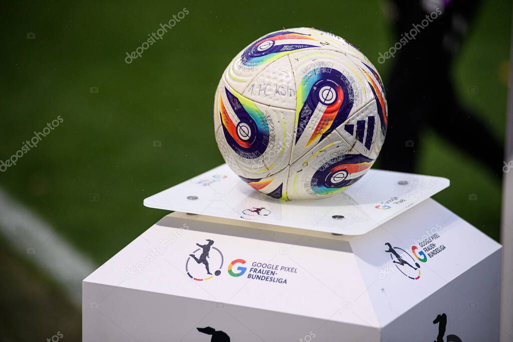 COLOGNE, GERMANY - 16 OCTOBER, 2025: Match ball on a Google Pixel Frauen-Bundesliga plinth at the touchline, raindrops visible. Clean league branding detail before kickoff.