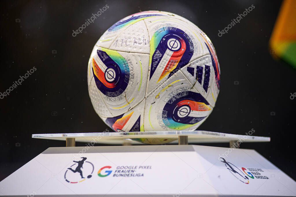 COLOGNE, GERMANY - 16 OCTOBER, 2025: Match ball on a Google Pixel Frauen-Bundesliga plinth at the touchline, raindrops visible. Clean league branding detail before kickoff.