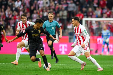 COLOGNE, GERMANY - 18 Ekim 2025: Dimitrios Giannoulis, Said El Mala - Bundesliga 1 'in futbol maçı. FC Koeln, FC Augsburg 'a karşı Rhein Enerji Stadyumu' nda.