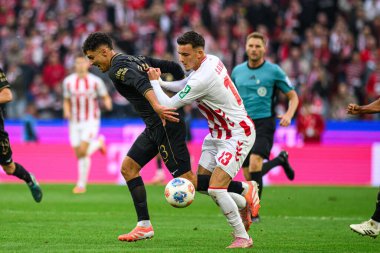 COLOGNE, GERMANY - 18 Ekim 2025: Dimitrios Giannoulis, Said El Mala - Bundesliga 1 'in futbol maçı. FC Koeln, FC Augsburg 'a karşı Rhein Enerji Stadyumu' nda.