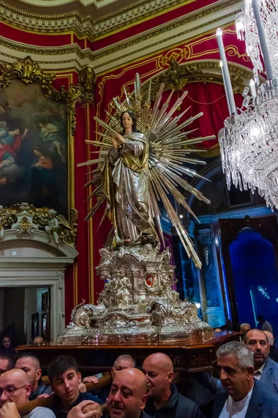 Cospicua, Malta - November 28th, 2025, Silver Statue Of Virgin Mary With Radiant Halo In Ornate Church Interior