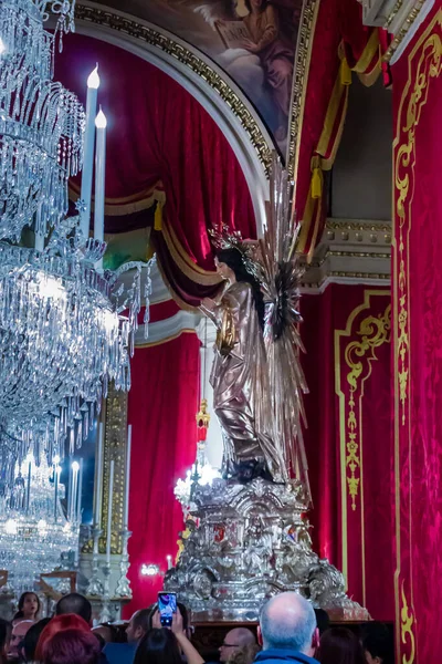 Cospicua, Malta - November 28th, 2025, Elegant Virgin Mary Statue Adorned With Gold Halo In Ornate Church Interior
