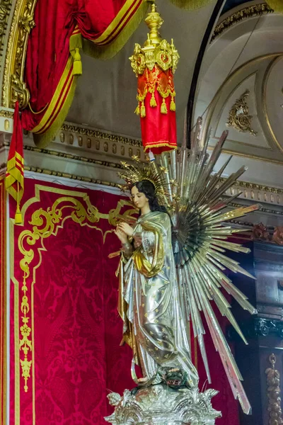 Cospicua, Malta - November 28th, 2025, Elegant Virgin Mary Statue Adorned With Gold Halo In Ornate Church Interior