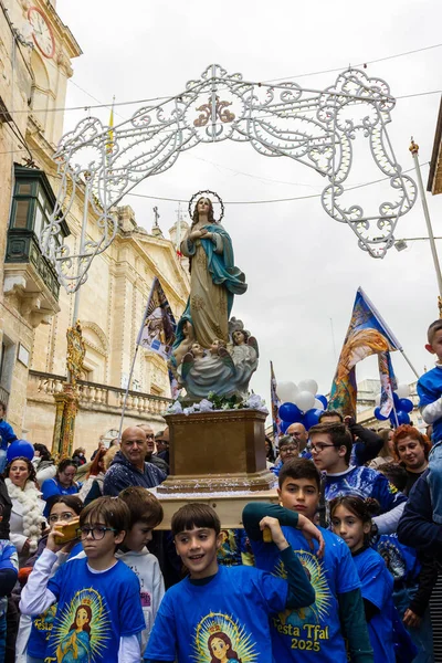 Cospicua, Malta - November 30th, 2025, Religious Festival Procession With Virgin Mary Statue Amid Crowded Street Parade During Festive Celebration