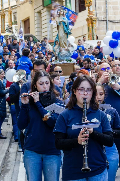 Cospicua, Malta - November 30th, 2025, Religious Festival Procession With Virgin Mary Statue Amid Crowded Street Parade During Festive Celebration
