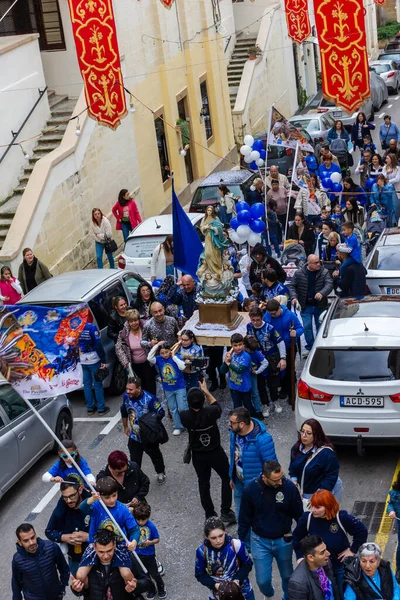 Cospicua, Malta - November 30th, 2025, Religious Festival Procession With Virgin Mary Statue Amid Crowded Street Parade During Festive Celebration