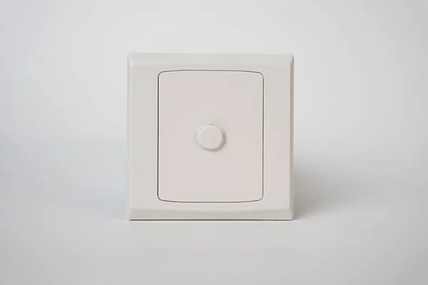 Minimalist photo of a small white safe with a circular dial lock on a light background, symbolizing security, protection, and privacy. Perfect for financial or data safety concepts.