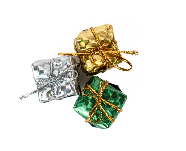 Mini gift boxes wrapped in shiny foil paper, isolated on white. Perfect for Christmas, New Year, or celebration design concepts. 