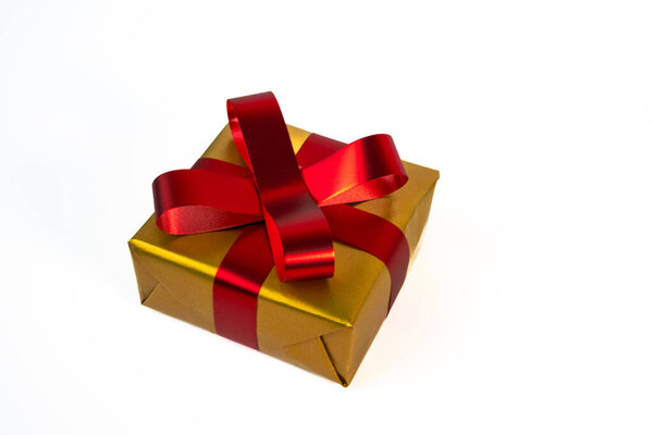 Elegant small red and gold present box with decorative ribbon, ideal for Christmas, New Year, or romantic celebration visuals. 