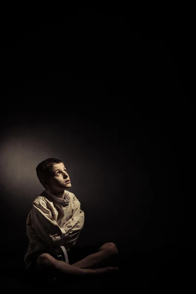 Thoughtful Lonely Boy Sitting in an Isolated Room — Stock Photo, Image