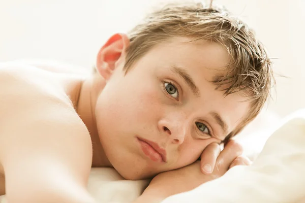 Teenage Boy Lying on Bed with Head on Hands — Stok fotoğraf