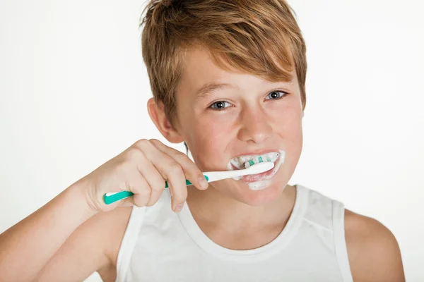 Sonriente adolescente niño usando cepillado dientes — Foto de Stock