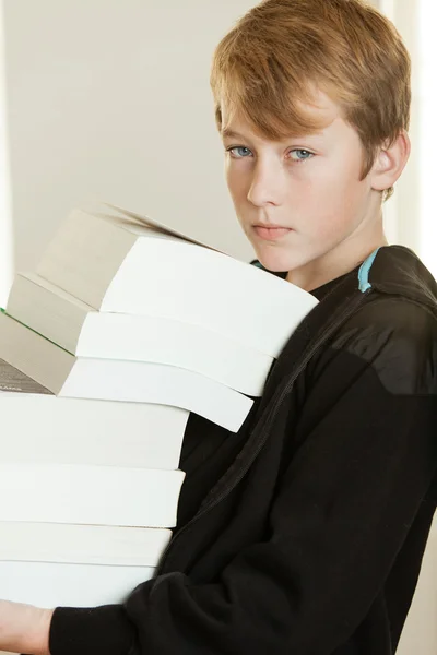 Boy in black hooded sweat shirt holding books — Stock Photo, Image