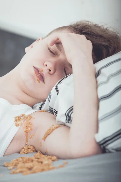 Teenage Boy Lying in Bed Covered in Vomit