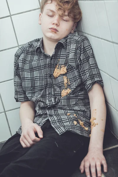 Drunk young boy asleep in the shower — Stock Photo, Image