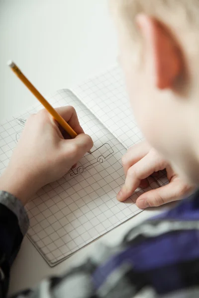 Young teenage boy doing homework — Stock fotografie