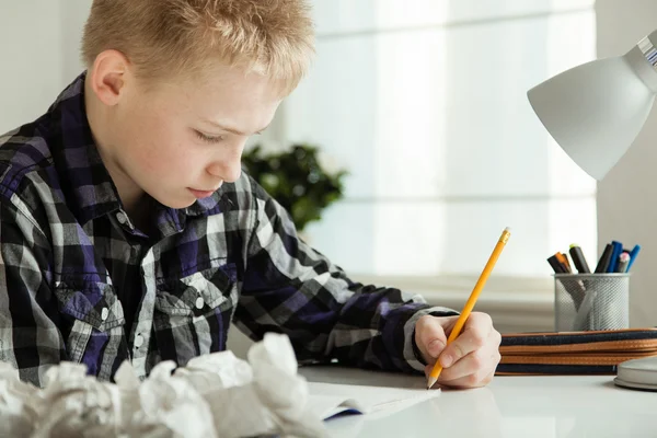 Young Teenage Boy Doing Homework at Desk in Home — Stockfoto