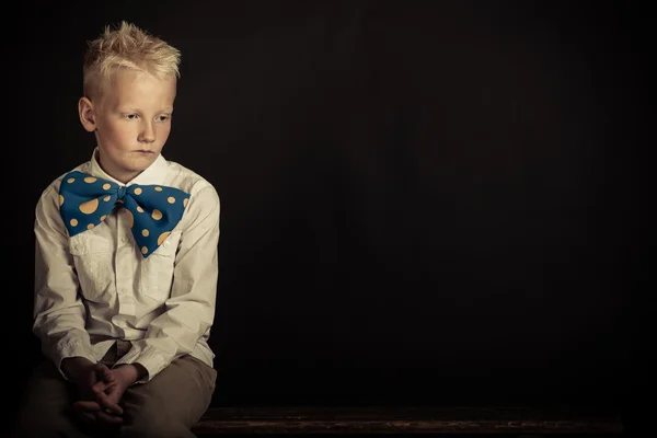 Sad boy in oversized bowtie with copy space — Stock Photo, Image