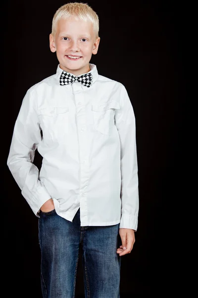 Boy standing with one hand in pocket smiles — Stock Photo, Image