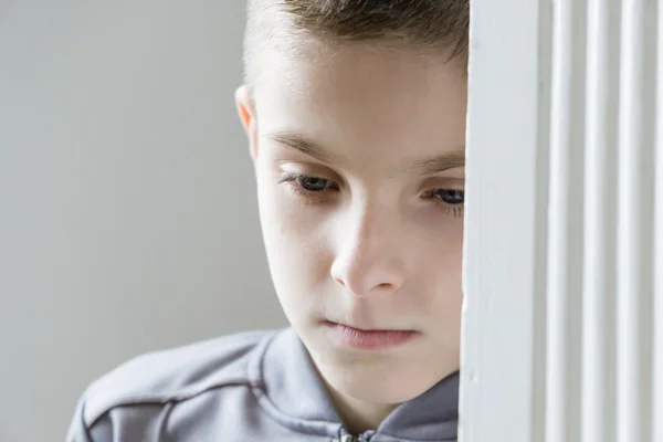 Close up of one depressed child in gray jacket — Stock Photo, Image