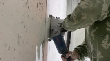 İşçi elektrikçi beton duvar inşaatçısı inşaat alanını kovalıyor 