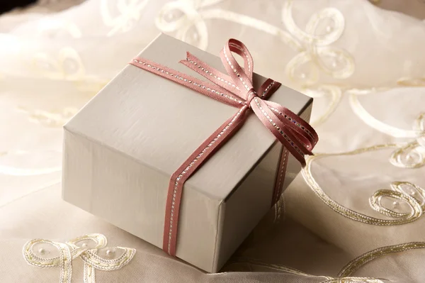 Gift box decorated with ribbon — Stock Photo, Image