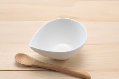 Clean one-sided sauce holder placed on a wooden table