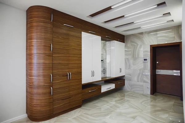 Wooden cabinet in modern hallway interior with luxury marble floor