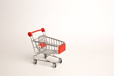 Beyaz arka planda izole edilmiş alışveriş arabası, oyuncak alışveriş arabası.