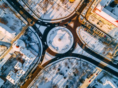 Kış güneşli bir günde, Avrupa 'nın küçük bir şehrinde yuvarlak arabalarla çevrili yol manzarası. Kyiv bölgesi, Ukrayna